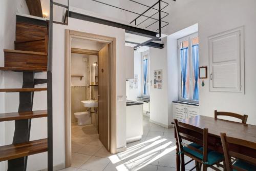 una cucina e una sala da pranzo con tavolo e bagno di Loft nel Centro di Alassio ad Alassio