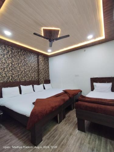 a bedroom with two beds and a ceiling at junagadh places in Ujjain