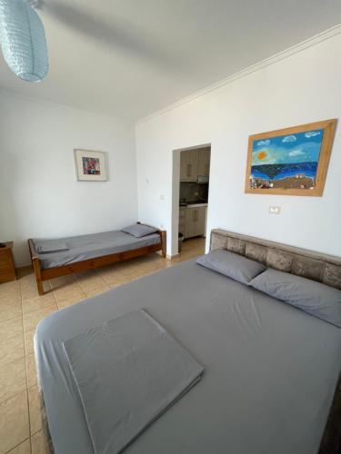 a bedroom with a large bed and a table at Vila Gusti in Borsh