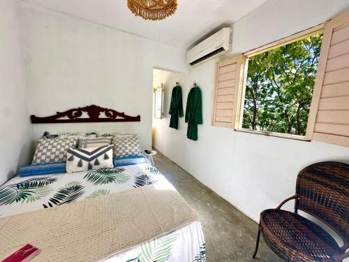 a bedroom with a bed and a window at Suítes - Village Capixaba in Gravatá