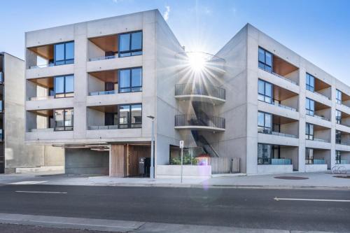 a building with the sun shining on it at Spacious Kingston Foreshore 1BR Apt - Hosted by Canstay in Kingston 