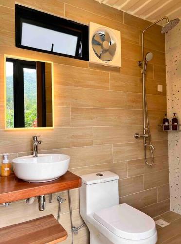 a bathroom with a sink and a toilet at The Black & White Box Villa - Genting Highland Foot Area in Bentong