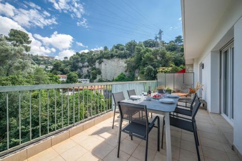 un balcon avec une table et des chaises et une vue dans l'établissement Ciel d'Orves - Terrasse Spacieuse- Parking privé, à Nice
