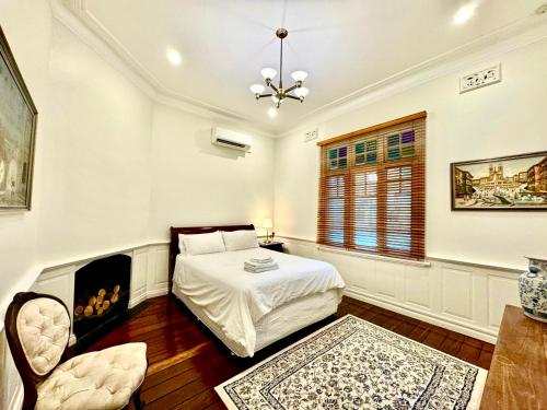 a bedroom with a bed and a fireplace at Charming Federation style home minutes from CBD in Perth