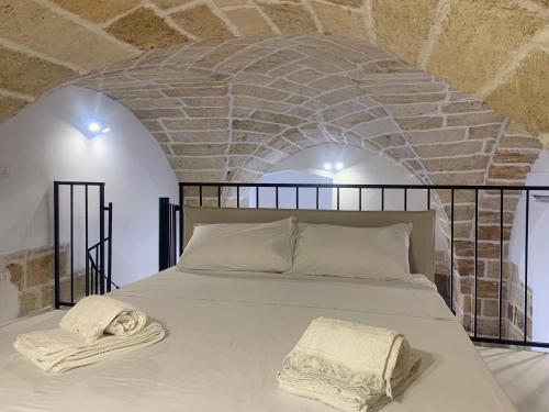 a bedroom with a bed with two towels on it at Le Dimore del Castello in Nardò