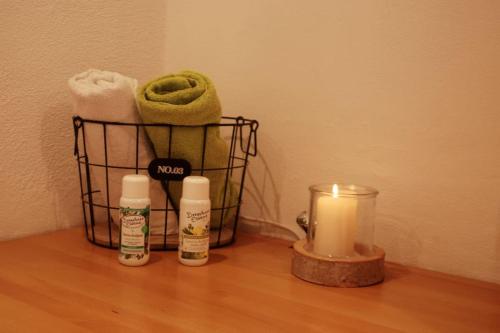 a candle and towels on a wooden table next to a candle at Time Out Moments Haus mit eigener Sauna in Grafenau