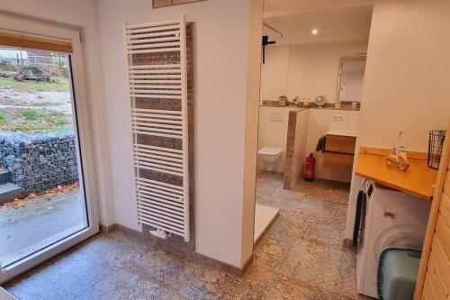 a bathroom with a sink and a window in a room at Time Out Moments Haus mit eigener Sauna in Grafenau