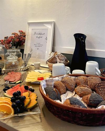 a table with a bunch of different types of food at Kirsebærkroen - The Inn Between in Præstø