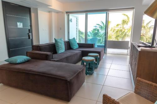 a living room with two couches and a couch at The Ocean Club, a Luxury Collection Resort, Costa Norte in Sosúa