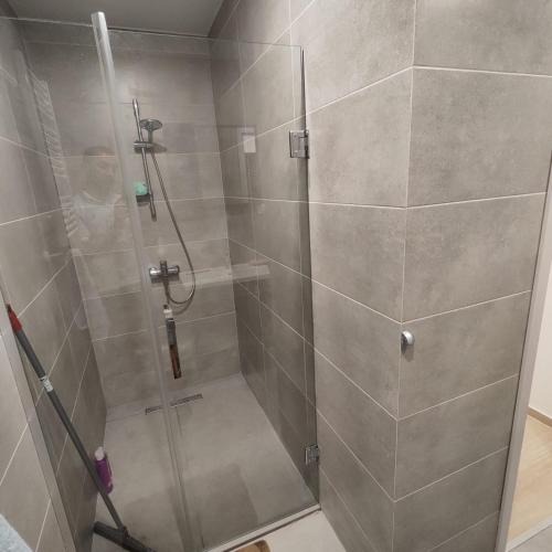a shower with a glass door in a bathroom at Moriya in Batumi