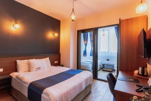 Ένα ή περισσότερα κρεβάτια σε δωμάτιο στο The Rest Port Hotel