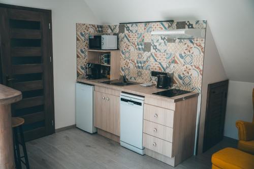 a small kitchen with a counter and a stove top oven at Apartmán Na Vrších in Nový Bozděchov