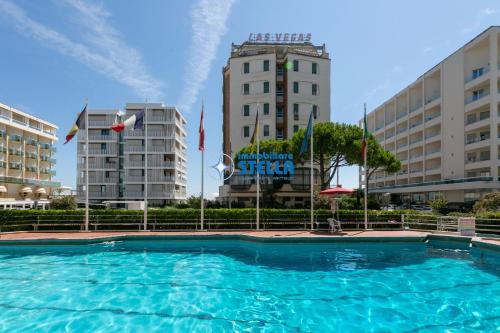 a large swimming pool in front of two buildings at Residence Vera Cruz in Lido di Jesolo