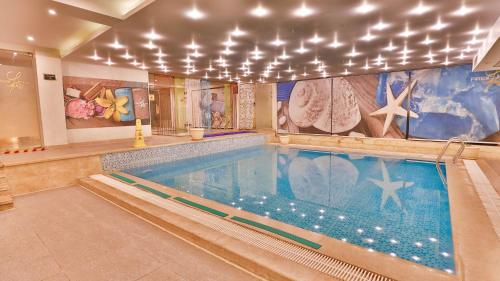 a large swimming pool in a building with a swimming pool at Amarina Abu Soma Resort & Aquapark in Hurghada