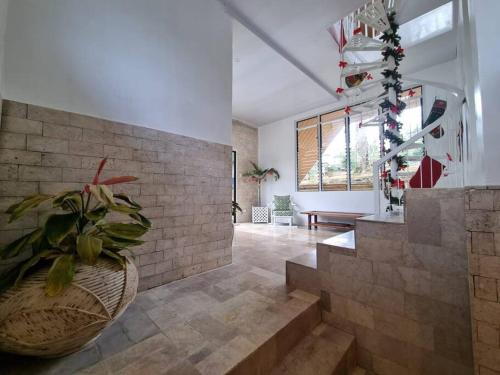 a lobby with a vase with a plant in it at Casa Manta Mountain home, pool, bonfire, camping in Ablayan