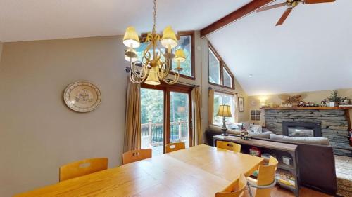 a dining room with a table and a fireplace at Dean Hill Chalet Brought to you by GetAway Vacations in Killington