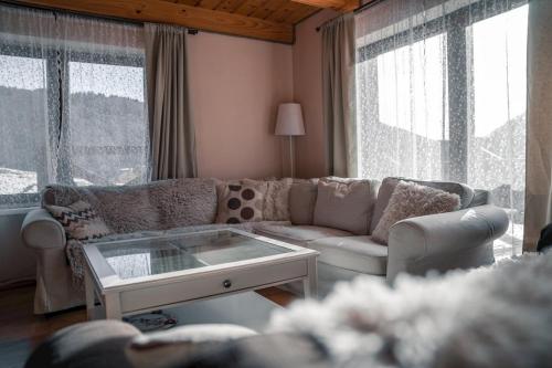 a living room with a couch and a coffee table at Chata Bystrá in Mýto pod Ďumbierom