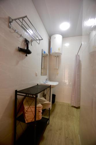 a bathroom with a sink and a mirror and a sink at Sarrof Guest House in Bukhara