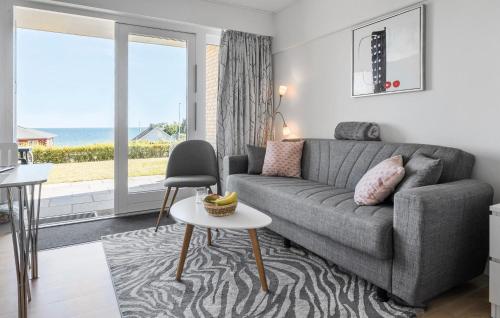 a living room with a couch and a table at Cozy Apartment In Allinge With Wifi in Allinge