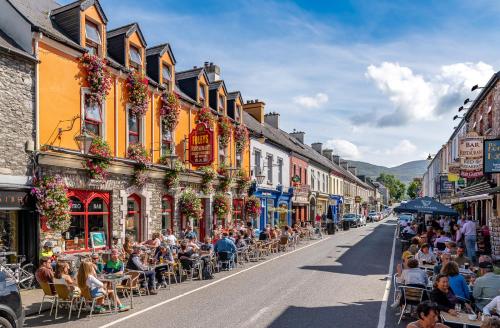 a group of people sitting in chairs on a street at Foley's Guesthouse & Self Catering Holiday Homes in Kenmare