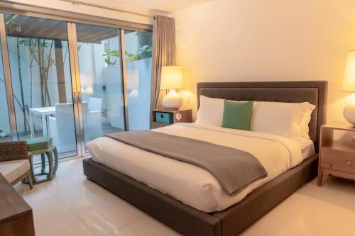 a bedroom with a large bed and a balcony at The Ocean Club, a Luxury Collection Resort, Costa Norte in Sosúa