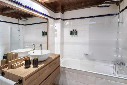 a bathroom with a tub and a sink and a bath tub at Meliá de Tredós in Tredós