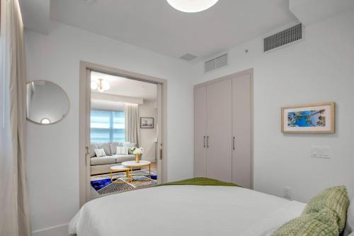a white bedroom with a bed and a living room at Vonder Miami Beach - Unit 5 in Miami Beach