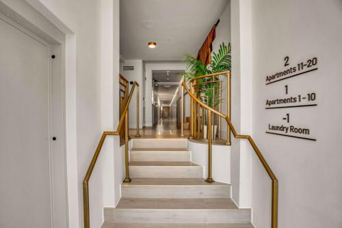 a staircase with gold railings in a hallway at Vonder Miami Beach - Unit 7 in Miami Beach