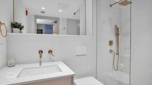 a white bathroom with a sink and a shower at Vonder Miami Beach - Unit 15 in Miami Beach