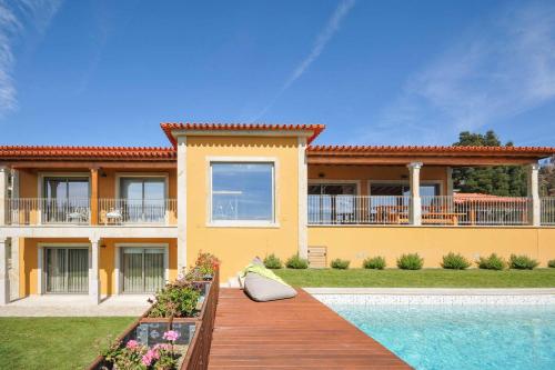 a house with a swimming pool in front of it at Casa Tranquilo in Refoios do Lima