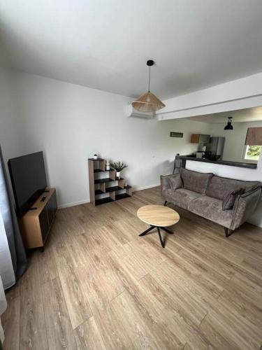 un salon avec un canapé et une table dans l'établissement Appartement en Brenne, à Vendoeuvres