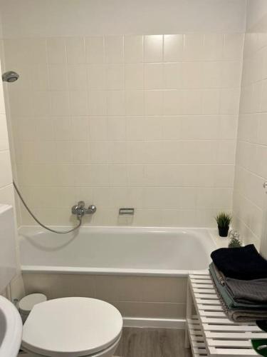 a bathroom with a toilet and a bath tub at Stilvolle Wohnung in Offenburg in Offenburg