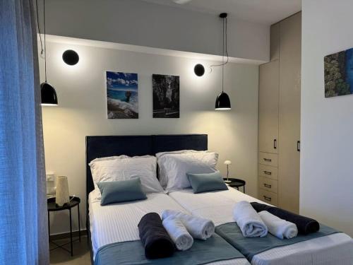 a bedroom with a large bed with three pillows on it at South Palms luxury village house in Áno Rodhákinon
