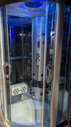 a shower in a room with blue lights at Vila N&M in Visoko