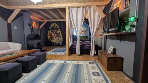 a living room with a bed and a tv at Vila N&M in Visoko