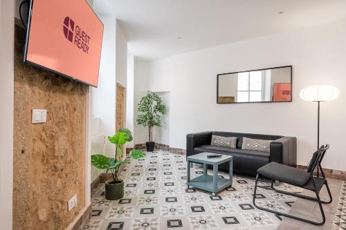a living room with a couch and a table at GuestReady - Serene Hideout in Downtown in Porto