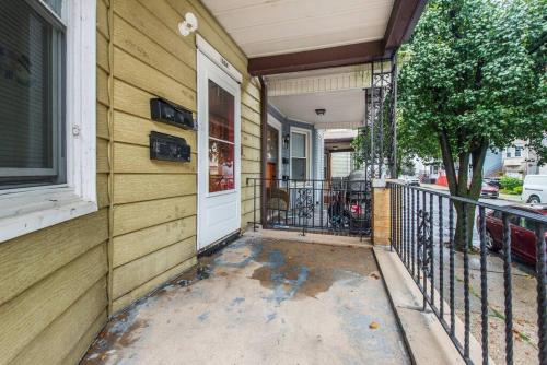 a front porch of a house with a white door at Happiness in Harrison in Harrison