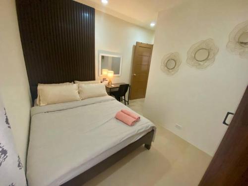 a bedroom with a bed and a table in it at Homestay CDO - Velmiro in Cagayan de Oro