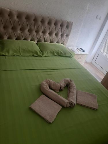 a bed with a heart shaped towel on it at Studio D&I in Vranje