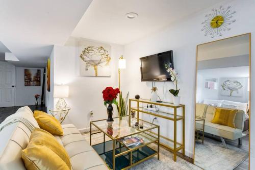 a living room with a white couch and a glass table at Luxury Suite by Prudential Ctr & 7min to EWR Airpt in Newark