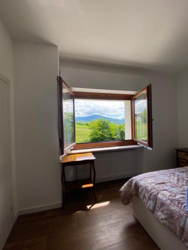 sypialnia z łóżkiem i oknem z widokiem w obiekcie B&B Panorama Dolomiti w mieście Mel