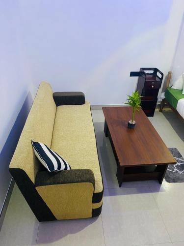 a living room with a couch and a coffee table at Cozy Homestay Waterfall Road Ella in Ella