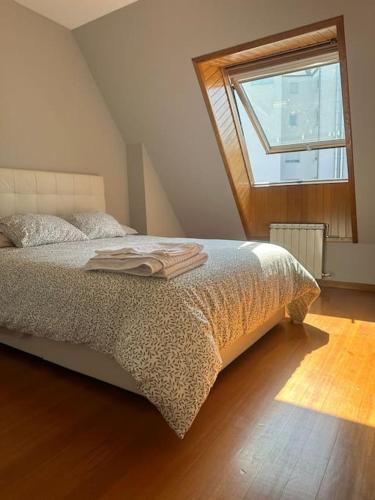 a bedroom with a bed with a large window at Increíble dúplex en Lugo in Lugo