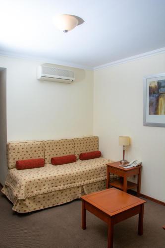 a living room with a couch and a table at Sol Victoria Hotel SPA & Casino in Victoria