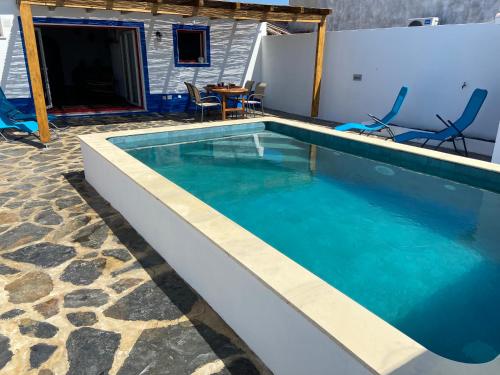 a swimming pool with blue water in a house at Casa da Oriola in Oriola