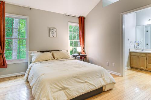 a bedroom with a large bed and a sink at Park Village Home with Pond 6 Mi to Downtown Cary in Cary