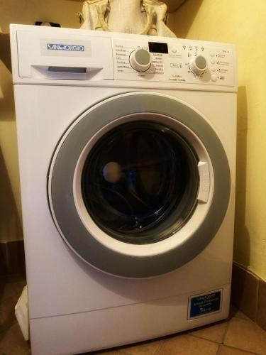 a white washing machine sitting in a room at A casa dei nonni in San Felice a Cancello