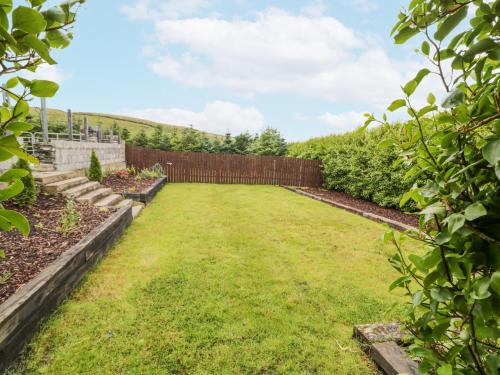 a garden with a fence and grass at Shroughan in Oldtown