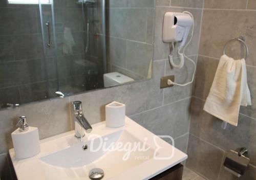 a bathroom with a sink and a shower at Departamento Av Diego de Almagro Copiapó, 2 habitaciones Disegni 08 in Copiapó