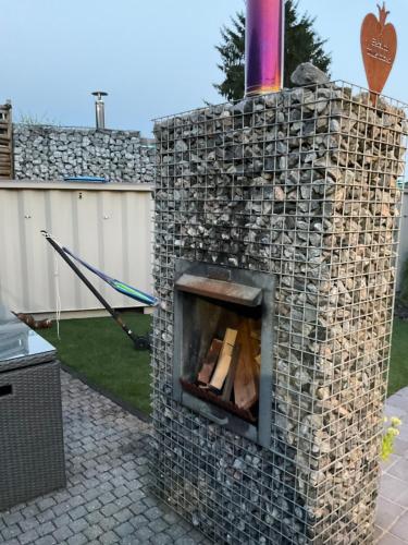 an outdoor brick oven with wood inside of it at Relax Trois Bornes - De Grenspost in Gemmenich